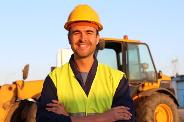 Construction driver with excavator on the background Construction driver with excavator on the background. switchboard operator stock pictures, royalty-free photos & images