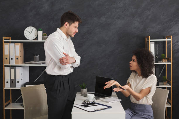 istock Couple of young colleagues arguing at office 959901130