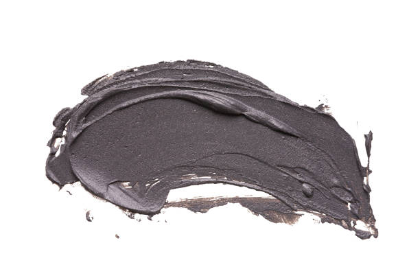 istock Black clay facial mask smear on white isolated background 959901628