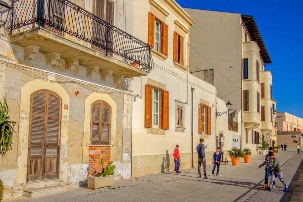 Children playing soccer in the Ortygia Island, a small island that constitutes the core of the historical center of Syracuse.