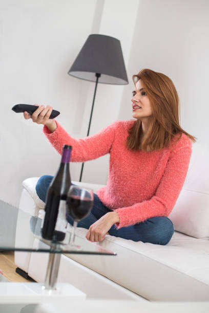 Woman watching TV at home