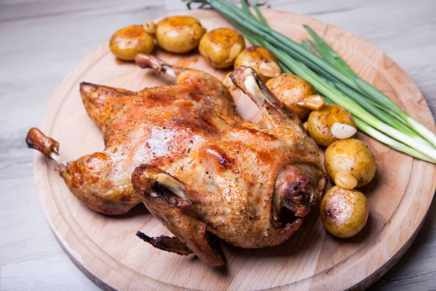 istock Whole baked duck, with potatoes and garlic. 959906320