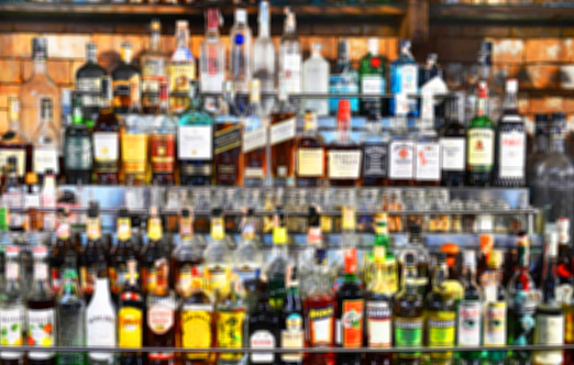 Blur bottles of spirits and liquor on bar counter,background