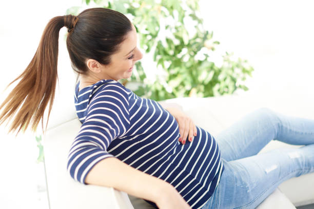 istock Pregnant woman relaxing on sofa 959909898