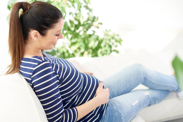 istock Pregnant woman relaxing on sofa 959909904