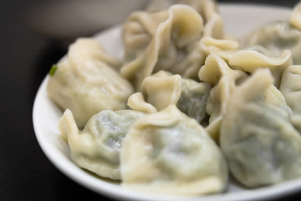 istock Asian dumplings stuffed with minced pork and vegetables 959910026