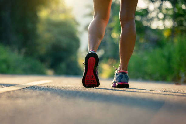 istock woman runner running on forest trail 959910298