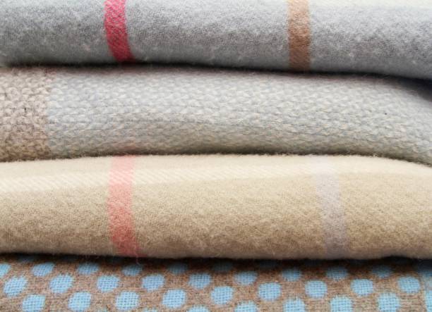 variety of grey toned blankets folded stock photo
