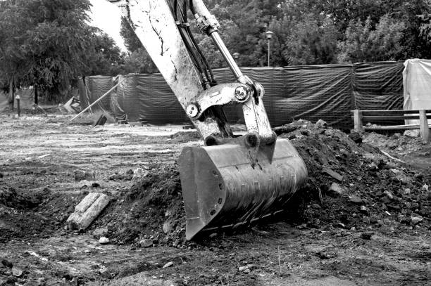 istock Bucket scoops the ground on the construction site,B&W 959911126