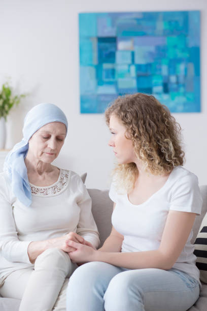 istock Caregiver and sad sick woman 959911376