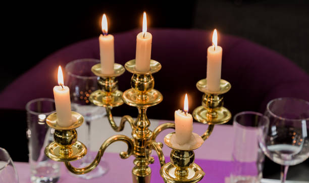 istock Glasses and a candlestick on a glass table in a restaurant. Romantic setting 959912202