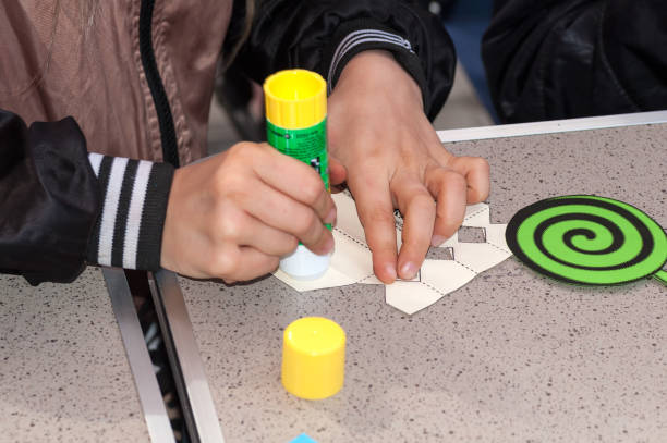 istock child glues from white paper in the master class 959914694
