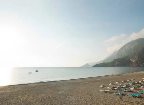 Looking past beach chairs towards Olympos Village ruins