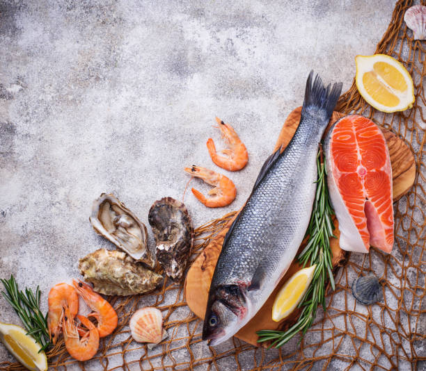 istock Seafood concept. Fish, shrimps and oysters. 959918224