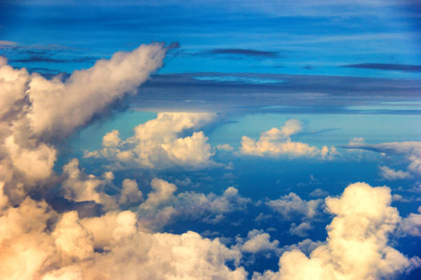 istock Clouds floating over the blue sea during flight. 959919750
