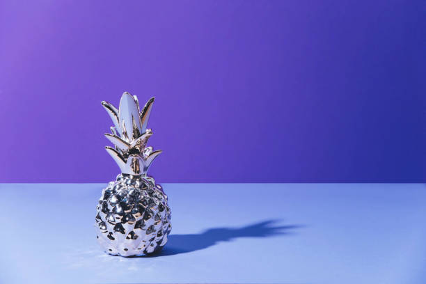 istock Tropical golden Pineapple on ultraviolet background 959919852