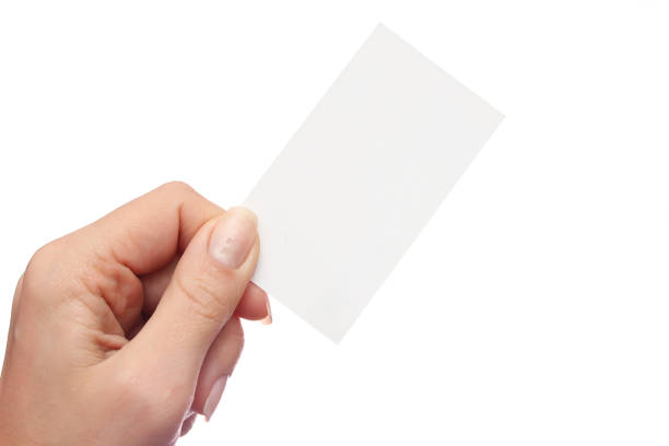 istock Female hand holds business card on white background 959923768