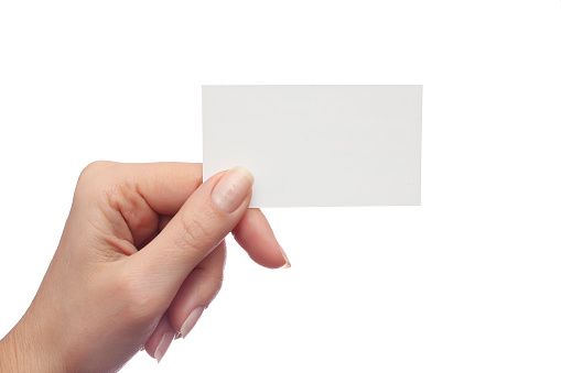 Female hand holds business card on white background
