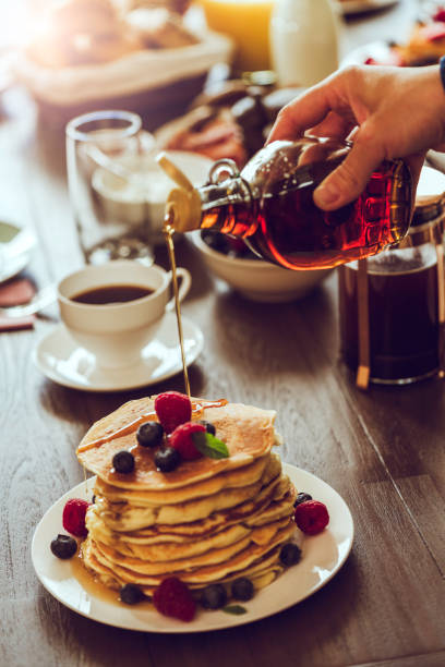 istock Stack of Pancakes with Maple Syrup, Berries and Fresh Coffee 959928092