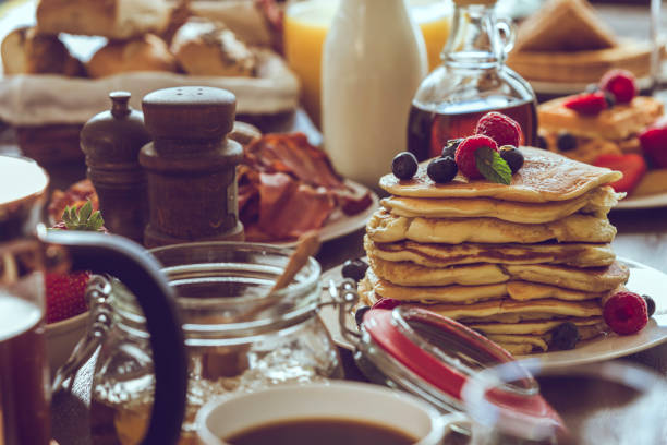 istock Stack of Pancakes with Maple Syrup, Berries and Fresh Coffee 959928104