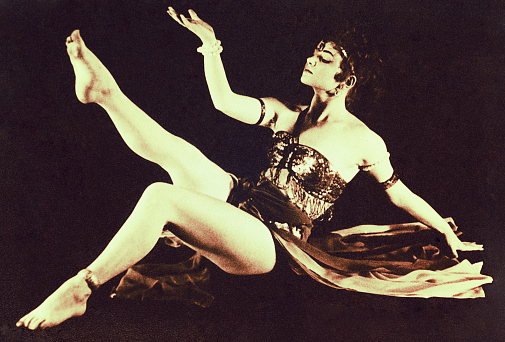 Vintage sepia toned photo of a young Asian dancer from the sixties of the twentieth century.
