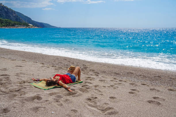 istock Women is lying on sand on the beach. 959934254