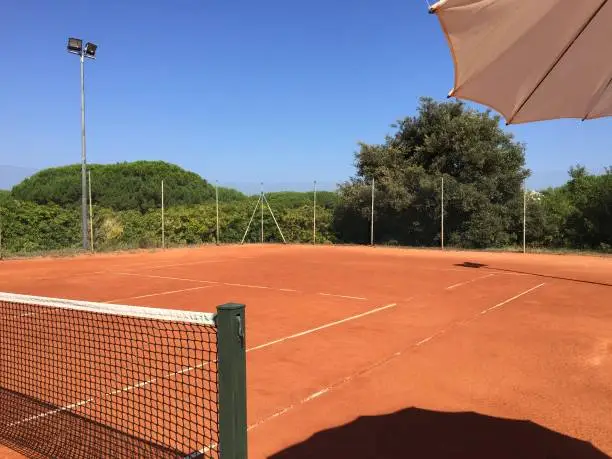 Red clay tennis court with net