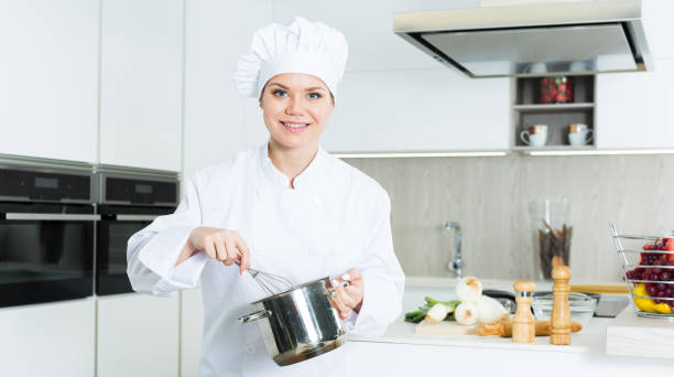 istock Woman professional is cooking soup in the kitchen 959937296