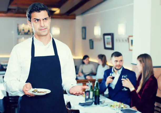 Photo of Waiter dissatisfied with small tip from cafe visitors