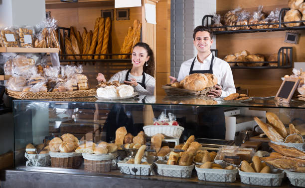 istock Couple selling pastry and loaves 959939094