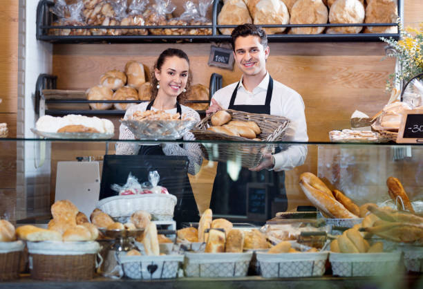 istock Portrait  couple at bakery display with pastry 959939242