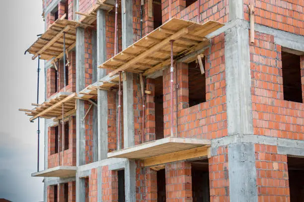 Unfinished brick house or building, still under construction. Close up.