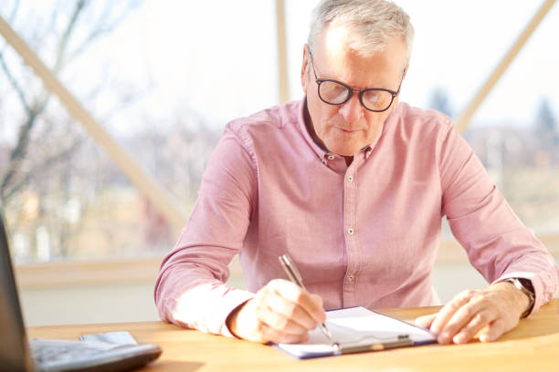 istock Senior businessman working at home. 959947152