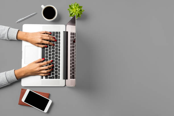 istock Woman working on laptop. Office desktop with copy space 959947386