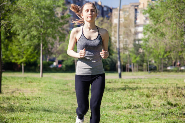 istock Young woman jogging in the park 959948008