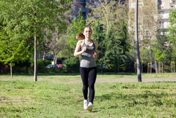 istock Young woman jogging in the park 959950548