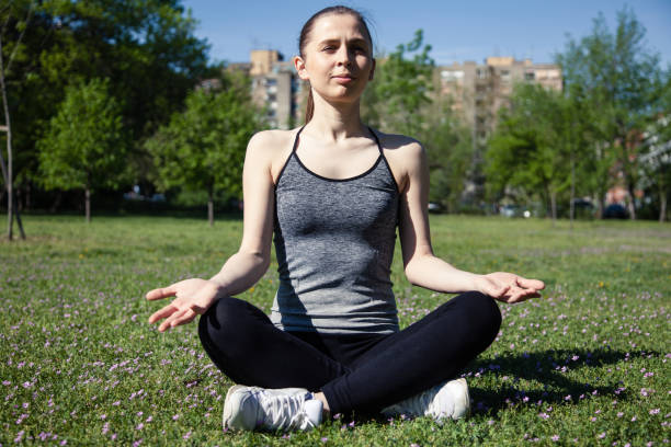 istock Woman practicing yoga outdoors 959952304