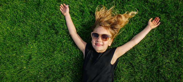 istock Little girl in a grass field 959952358