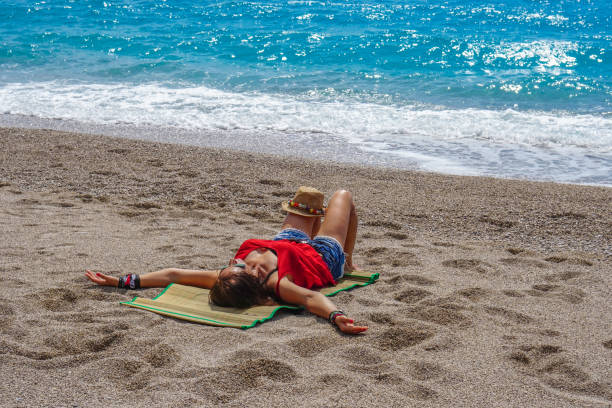 istock Women is lying on sand on the beach. 959956298