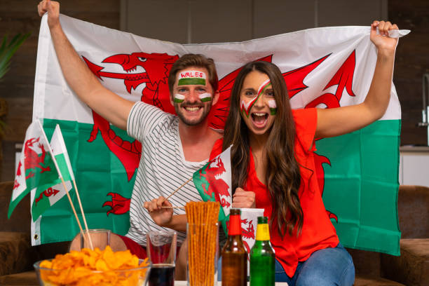 istock soccer fan couple cheering for wales 959960794