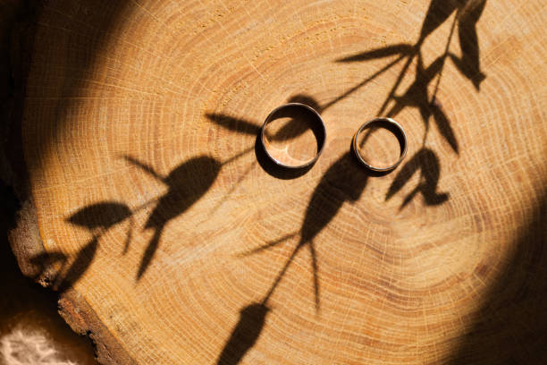 istock Wedding rings on a wooden texture surface. 959964244