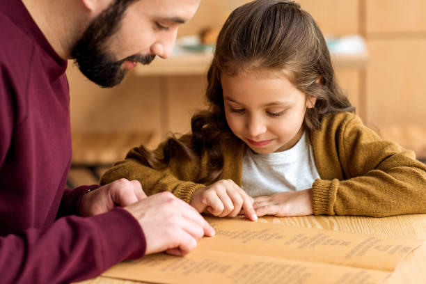istock father and daughter choosing food in menu 959965242