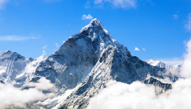 Mount Ama Dablam within clouds, way to Everest base camp Mount Ama Dablam within clouds, way to Everest base camp, Khumbu valley, Sagarmatha national park, Everest area, Nepal base camp photos stock pictures, royalty-free photos & images