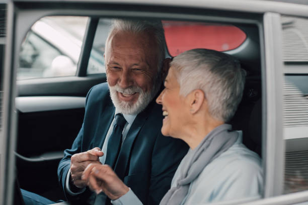 istock Senior couple laughing in business car 959965672