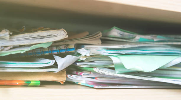 istock Stacks of notebooks and school supplies - a mess 959966092