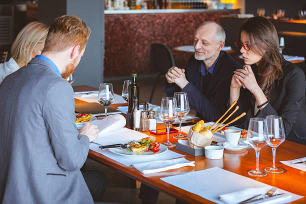 istock Group of Friends Having a Conversation During Lunch Time in a Cafe / Restaurant 959966420