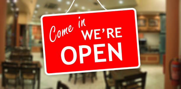 istock We are open sign hanging on a glass storefront 959970182