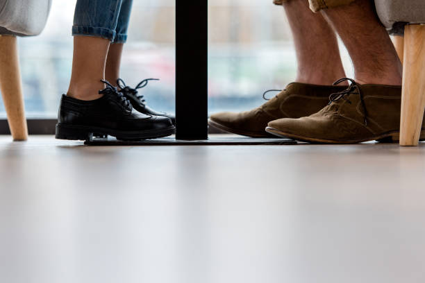 istock cropped image of father and daughter legs under table 959974310