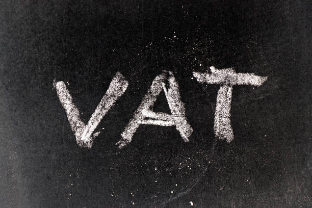 istock White chalk drawing in VAT (Value added tax) on black board background 959978050