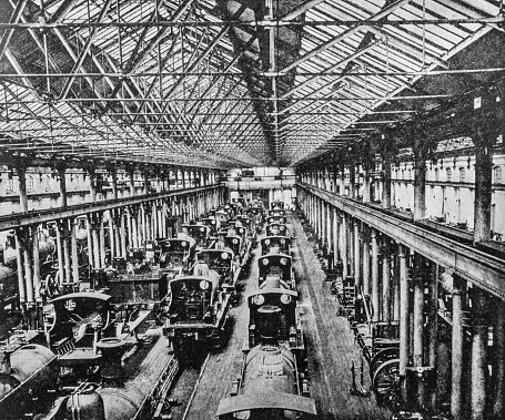 Steam engine trains in an erecting shop in Derby. Heavy industry inside a train yard in Derby from the pre-1900 book 